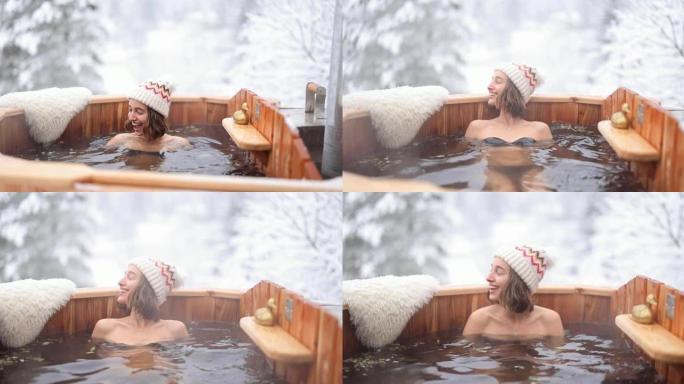 女人在雪山的热水浴中放松