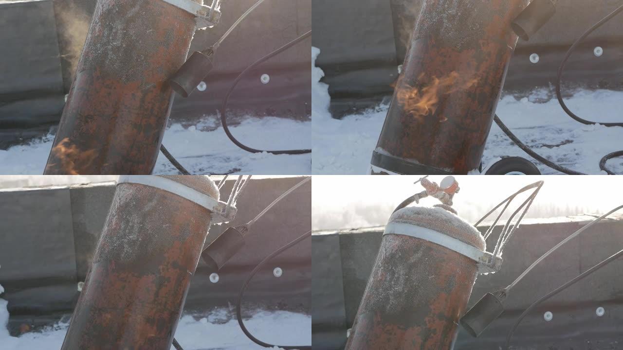 北方，北极。一名工人用在寒冷中结冰的火加热丙烷罐。违反安全规定