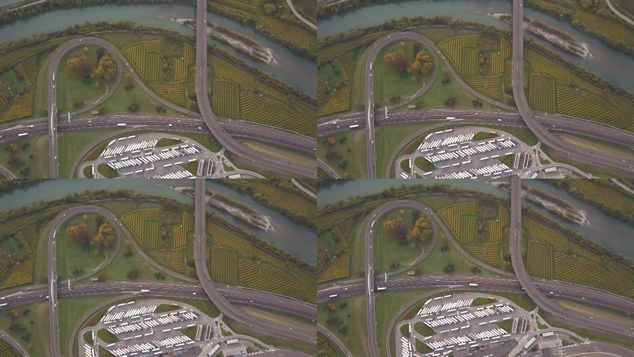 高速公路州际公路的俯视图，交通快速，停车场停放卡车。
