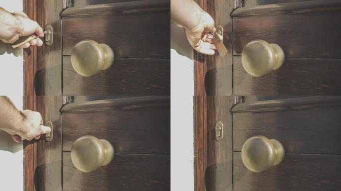 门锁里有一把钥匙。手拿着钥匙转动