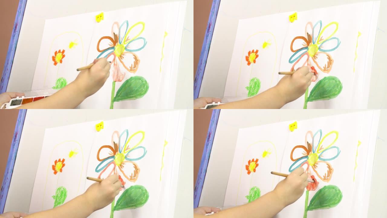 特写儿童画架上水彩画手绘花。幼儿园，绘画课。4k