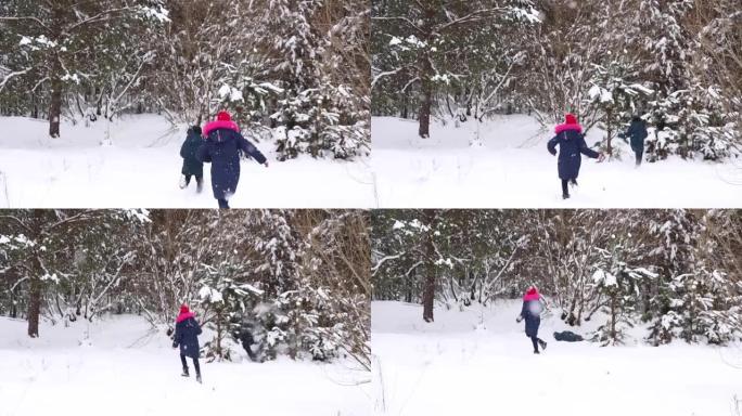 散焦男孩和一个女孩雕刻雪球。有趣的孩子在冬季公园玩雪球，积极地花时间在户外冬季白雪皑皑的林地寒冷的霜
