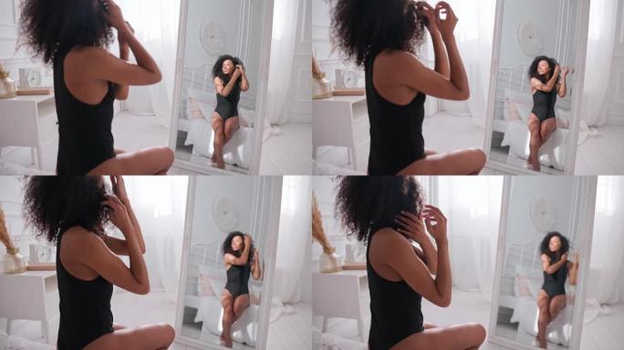 黑人妇女抚摸她的头发，坐在床上照镜子，护发