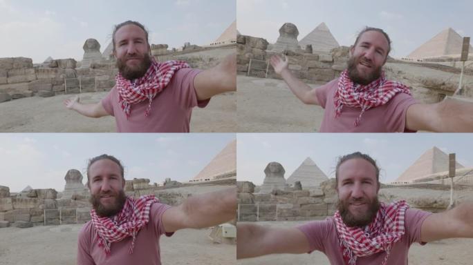 年轻人旅行在吉萨大金字塔前自拍。男性在埃及开罗与金字塔和狮身人面像一起自拍