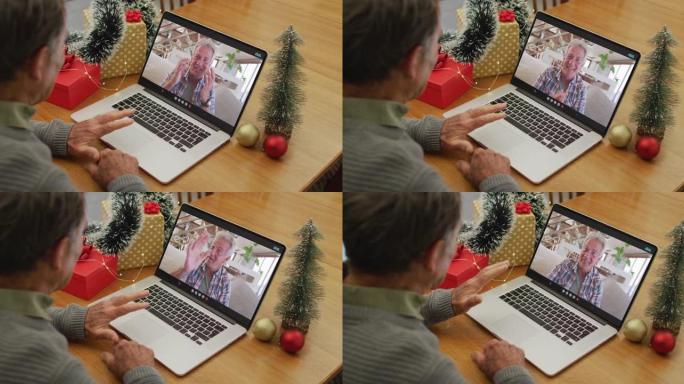 快乐的高加索高级男子在圣诞节与男性朋友进行视频通话