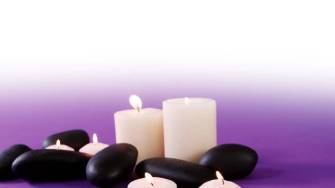 白色和紫色背景上的黑色岩石和白色蜡烛的动画