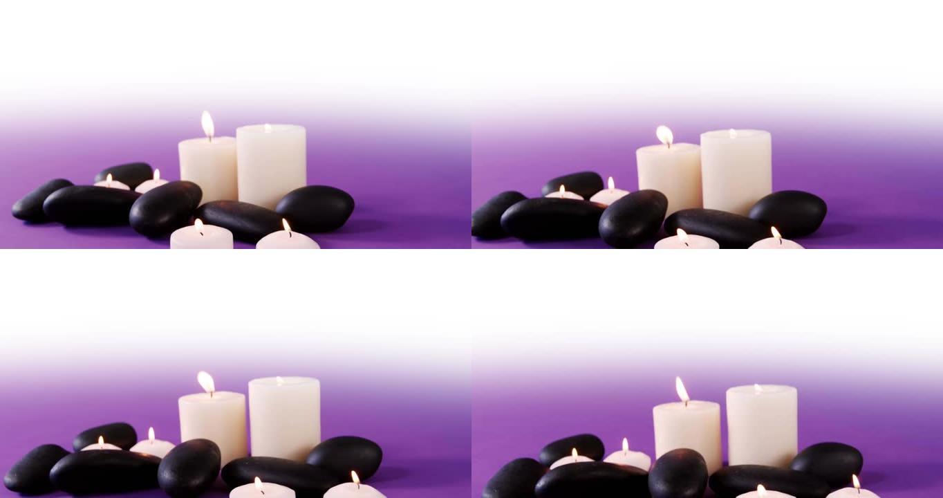 白色和紫色背景上的黑色岩石和白色蜡烛的动画