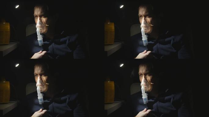 一个中年男人做喷雾器呼吸的肖像。吸入肺部有强烈的咳嗽。夜晚，灯发出的光。一个男人的脸特写