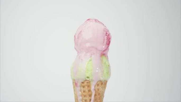 在顶级冰淇淋果子露上舀冰淇淋草莓。