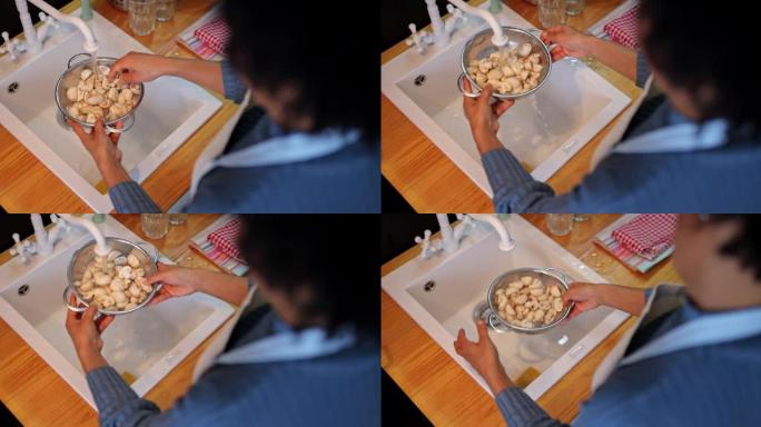 女人在家里厨房做午餐前洗白蘑菇