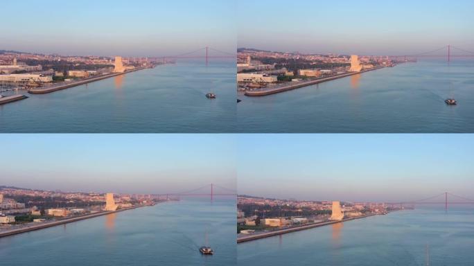 俯瞰葡萄牙发现纪念碑的美妙日落景观，帕德拉奥·多斯·德斯科布里门托。贝伦。背景中的4月25日桥。