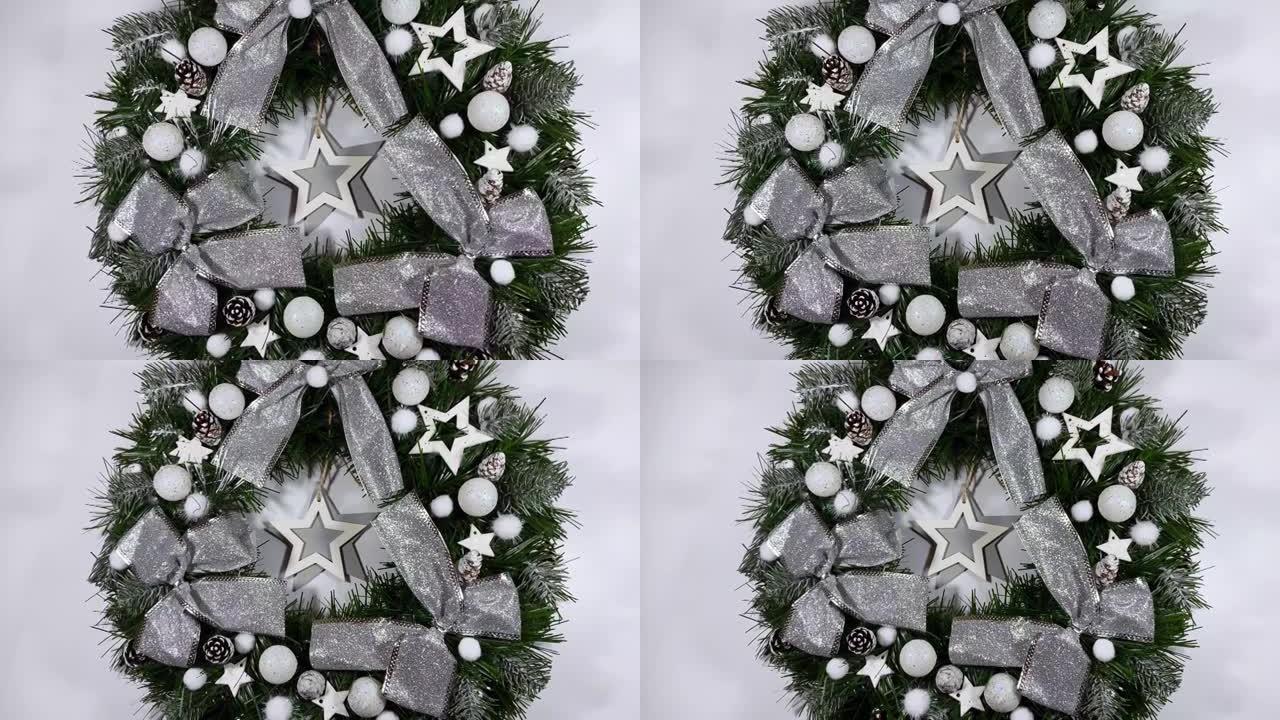 圣诞花环装饰节日前门，由云杉、银色蝴蝶结、星星和孤立在白色背景上的圣诞球制成