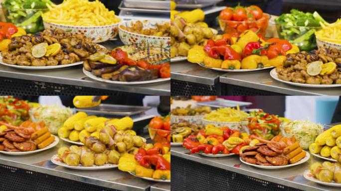 各种令人惊叹的街头美食选择。柜台上有肉类菜肴和煮熟的蔬菜。节日的快餐