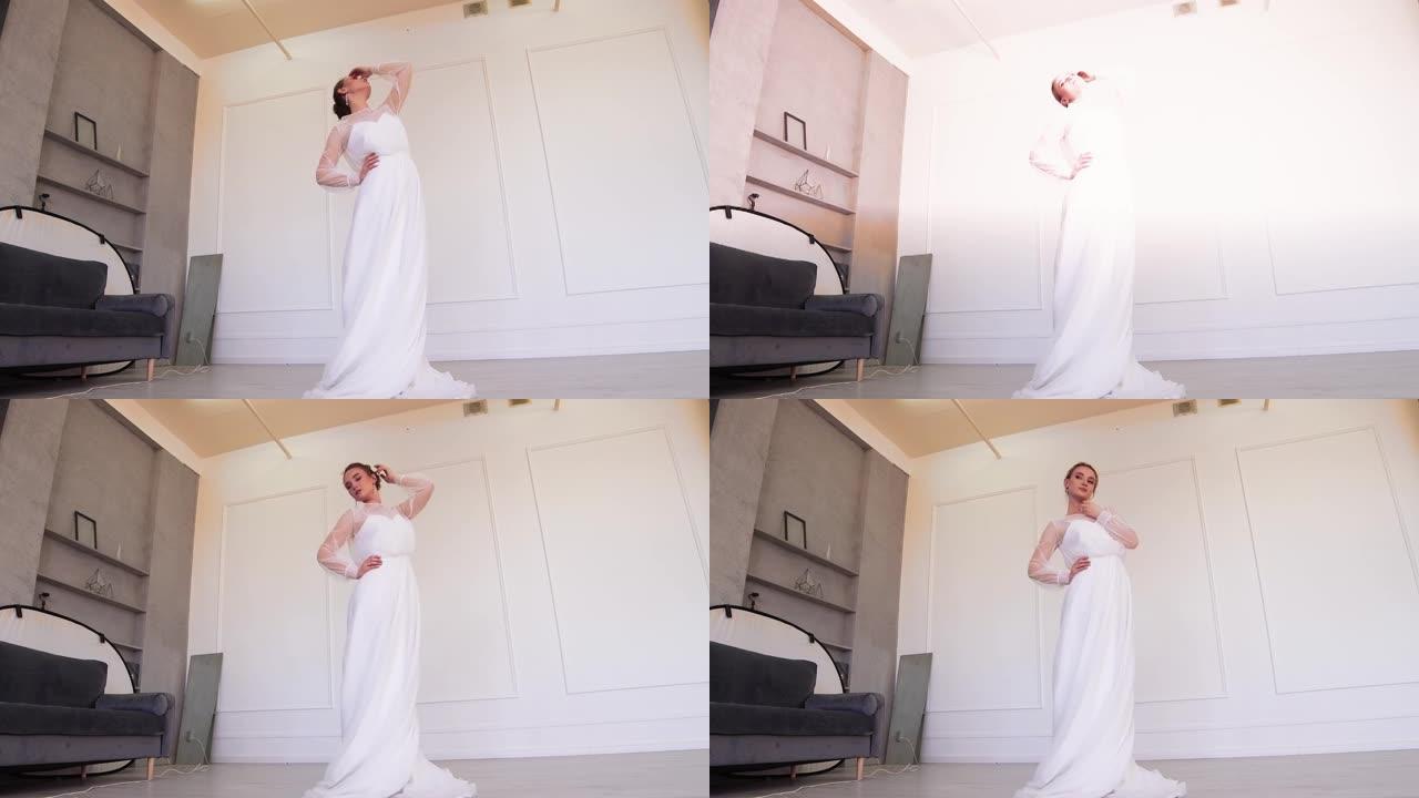 美丽的新娘穿着白色连衣裙，站着为摄影师摆姿势。