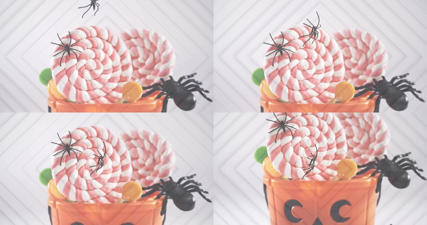 蜘蛛掉在万圣节南瓜桶中，里面装满糖果，对着同心方块