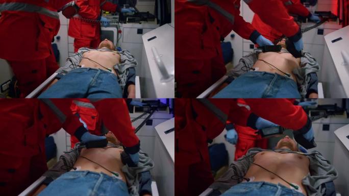急救医生在救护车中对患者使用心脏除颤器