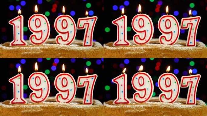 生日蛋糕与白色燃烧的蜡烛在数字1997的形式