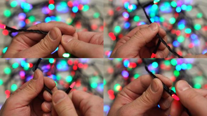 男子试图解开一连串的圣诞节花环