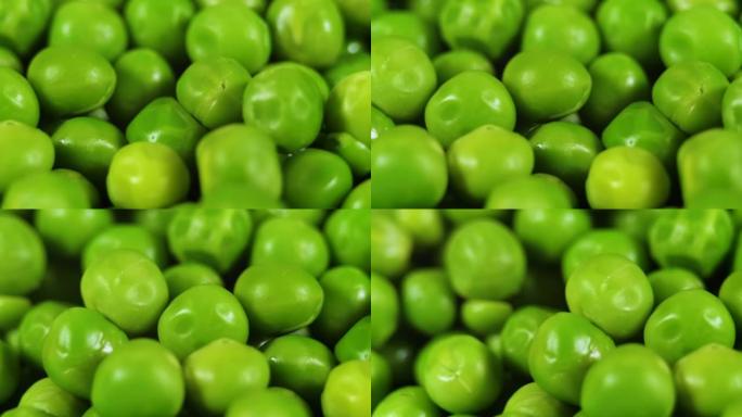 宏观拍摄新鲜有机豌豆。健康素食。关闭绿色豌豆背景旋转。蔬菜收获健康饮食。新鲜绿豌豆的美丽纹理特写。
