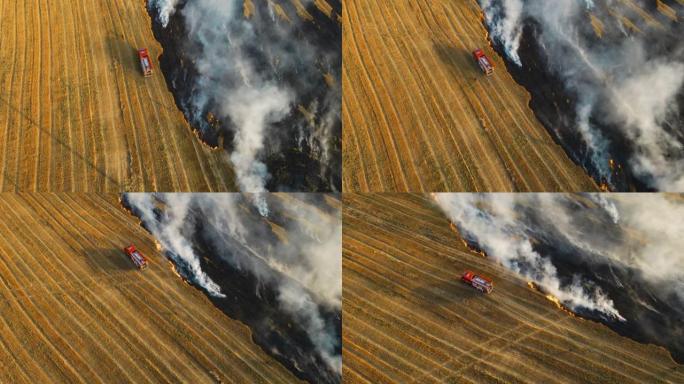 消防车在田间行驶，向燃烧的小麦作物喷洒烟熏火
