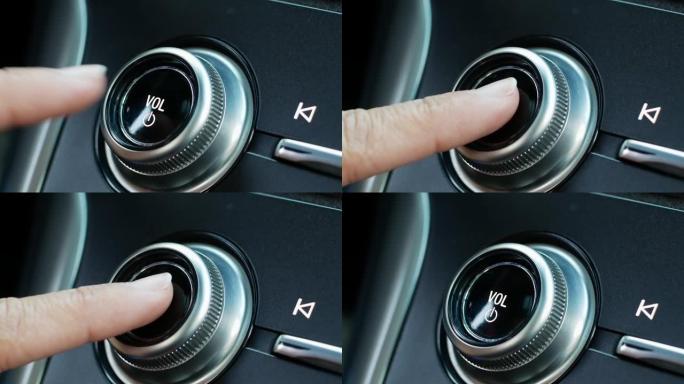 一名妇女通过按下现代汽车中的电源按钮来打开音频系统