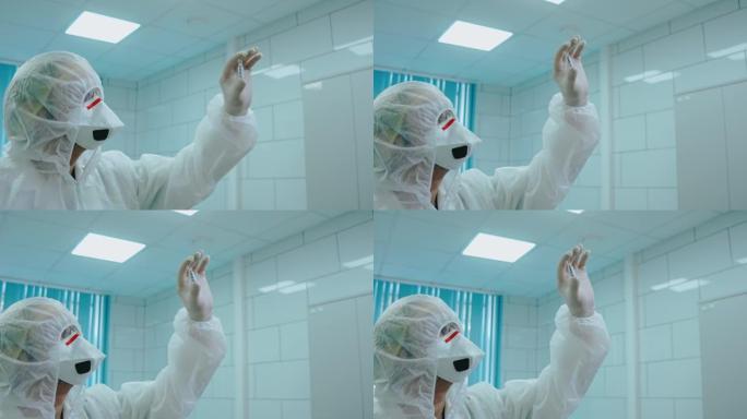 科学家在实验室的灯上拿着新型冠状病毒肺炎试管的防护服