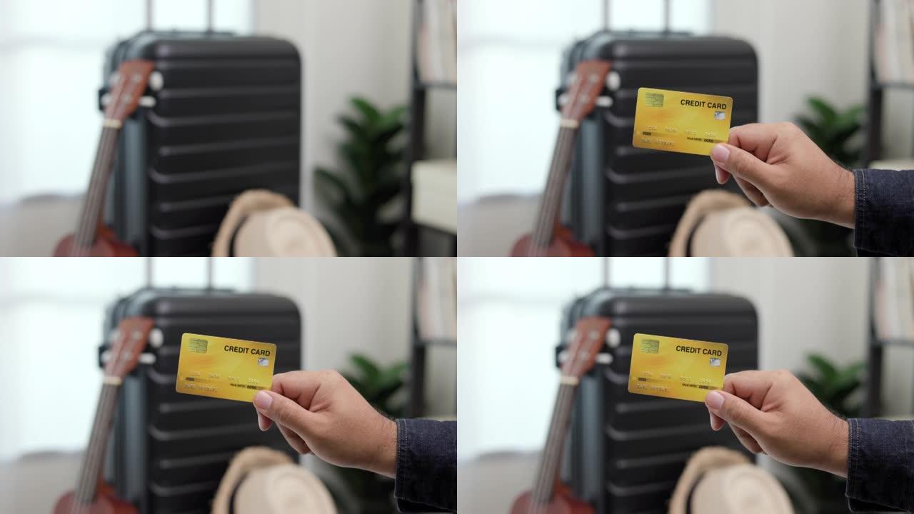特写旅行者手汉展示信用卡支付的旅行。背景上的拉杆包。旅行奖励点。游客会员卡计划