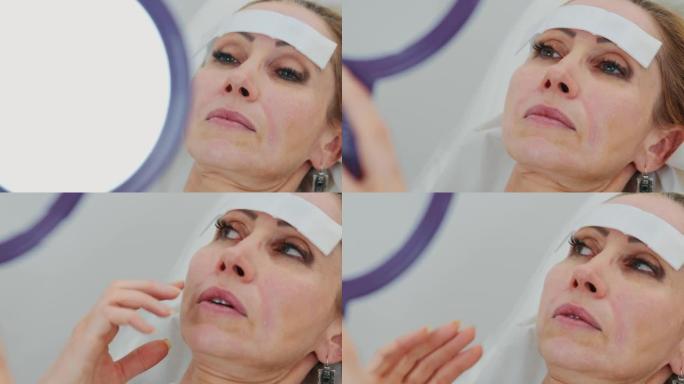 特写镜头女性患者在鼻唇沟注射透明质酸后照镜子，看结果，与医生谈论美容治疗