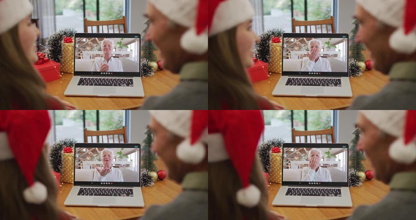 快乐的高加索老人和孙女在圣诞节与祖母进行视频通话