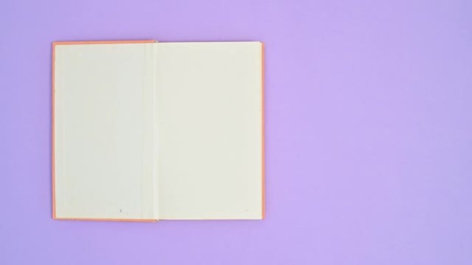 橙色精装复古书从紫色主题的右侧移动到左侧并打开。停止运动平铺
