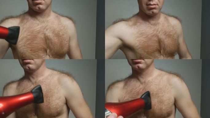 一名体毛增多的男子用吹风机收窄他的红色胸毛