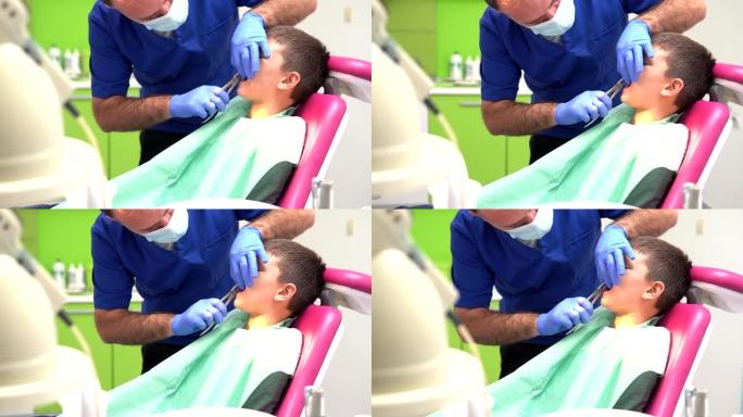 牙医用特殊的钳子拔男孩的牙齿