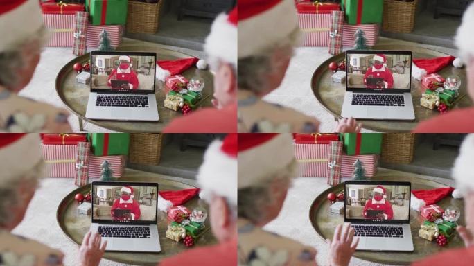 高级高加索夫妇使用笔记本电脑与屏幕上的圣诞老人进行圣诞节视频通话