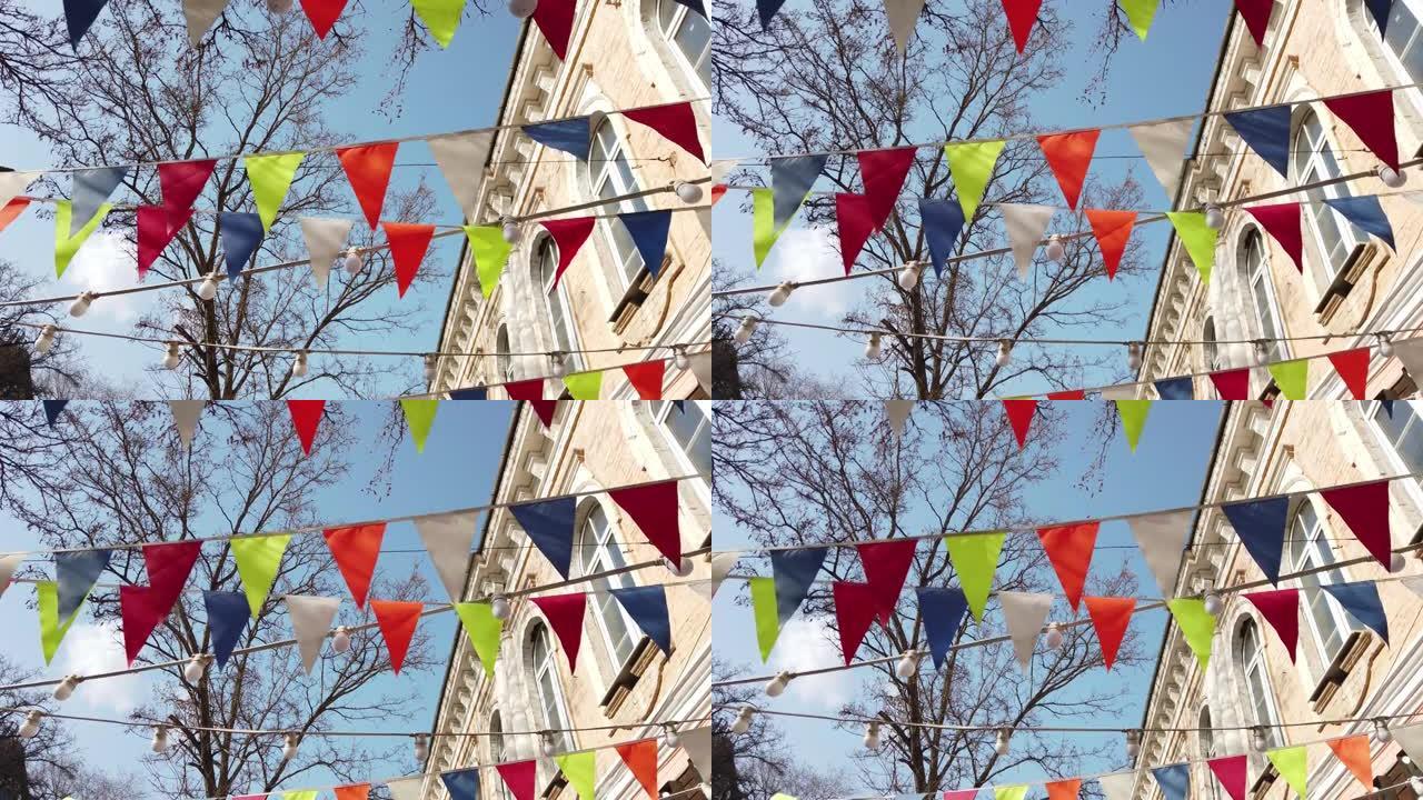 派对装饰，城市为庆祝城市活动准备的天空前鲜艳的三角形旗帜
