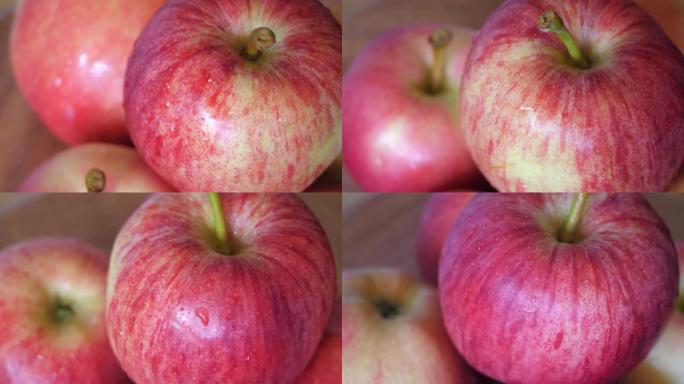 gala品种的几个苹果特写视频。苹果皮上的水滴。