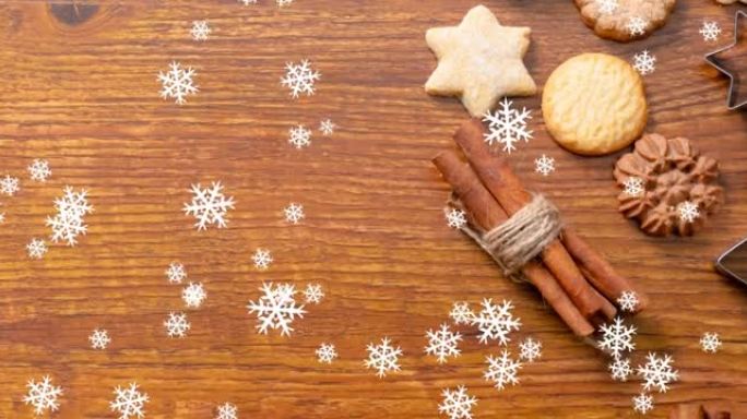 桌子上的圣诞饼干上飘着雪的动画