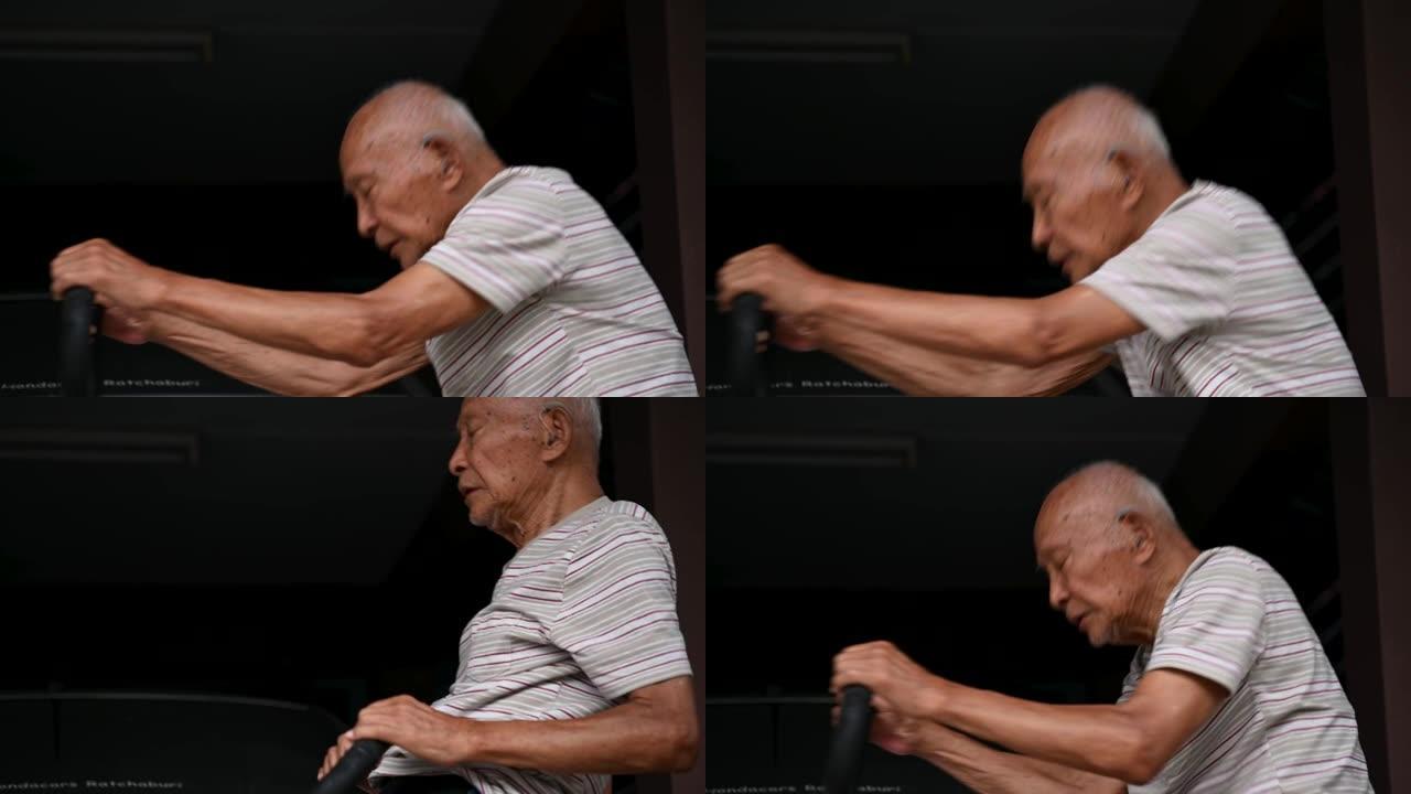 一位九十多岁的亚洲男子正在与1英尺摇杆一起锻炼