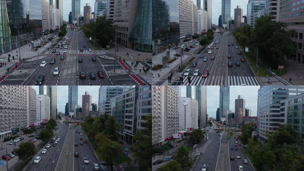 城市多车道道路上汽车行驶的前瞻性跟踪。高大的现代办公楼或公寓楼。波兰华沙
