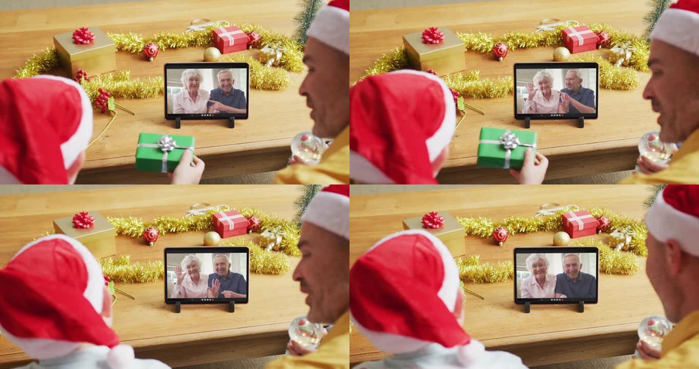 带有圣诞老人帽子的高加索父子使用平板电脑进行圣诞节视频通话，屏幕上有情侣