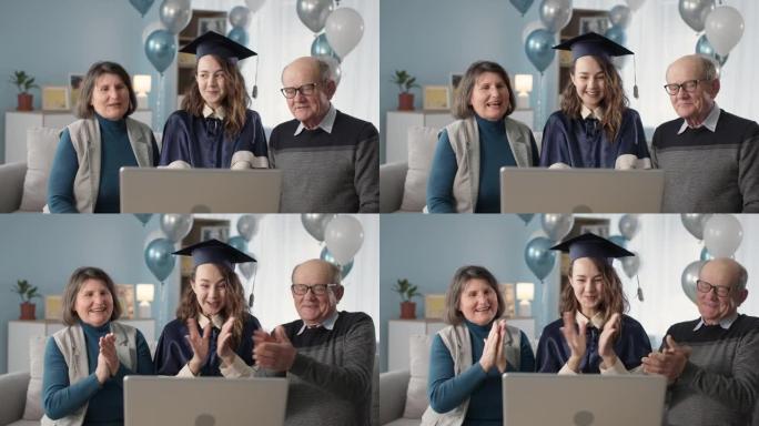 在线毕业典礼，爱心父母和研究生女儿通过视频链接在客厅的家中庆祝毕业