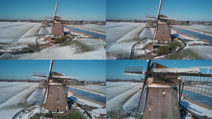 在厚厚的积雪下，海牙附近的Molendriegang Drie Molens的航拍镜头