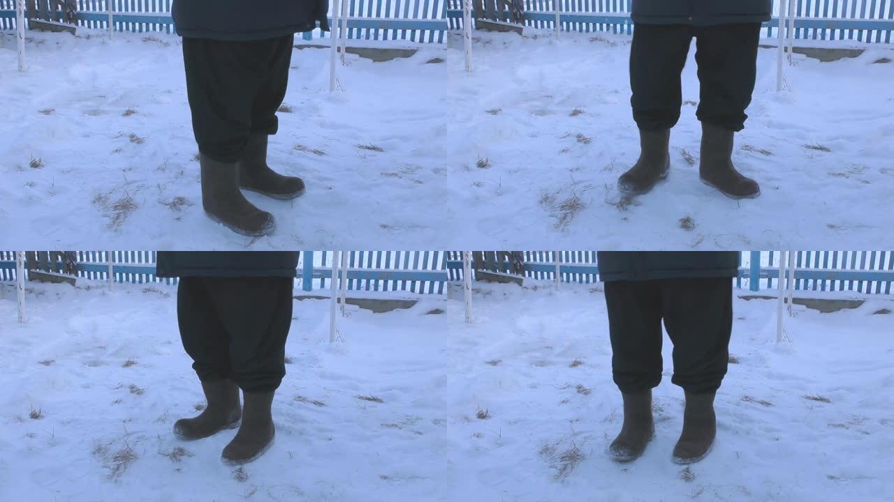 一个穿着冬装和靴子的男人在街上