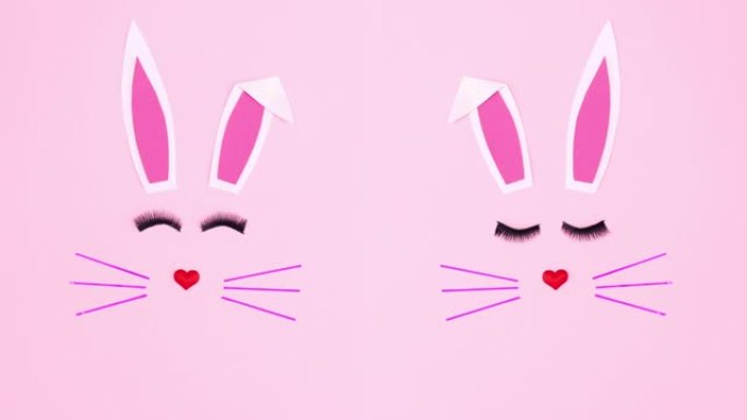 粉色背景上的创意双复活节兔子。停止运动