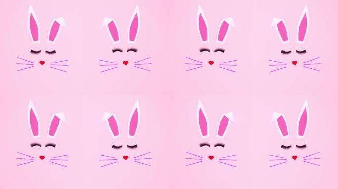 粉色背景上的创意双复活节兔子。停止运动