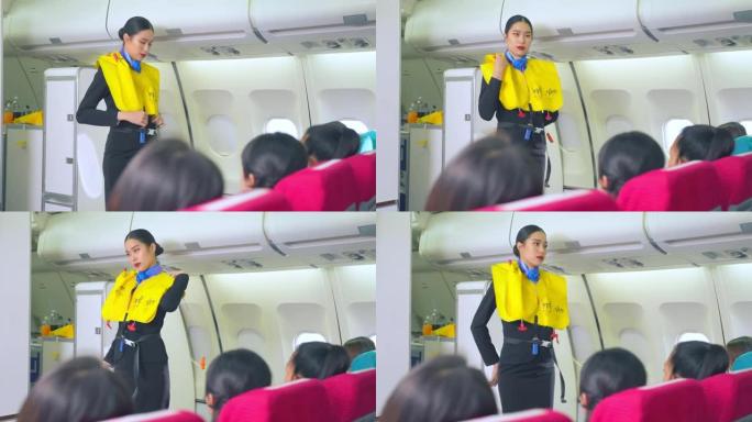 亚洲空姐解释并展示起飞前在飞机上抛弃时使用救生衣的安全演示。机组人员在飞行过程中演示乘客安全。