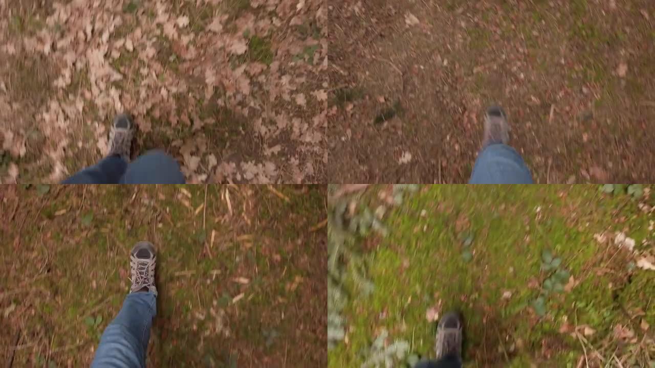 顶视图男性脚穿着登山靴穿过森林地面实时多云白天