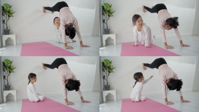 快乐的亚洲女孩用白墙锻炼，而她的妹妹想在家里和她一起玩，生活方式理念。
