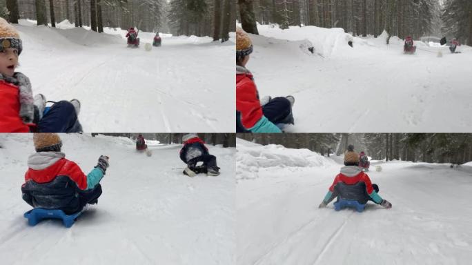 快乐的孩子，在塑料雪橇上下坡，超速行驶，幸福