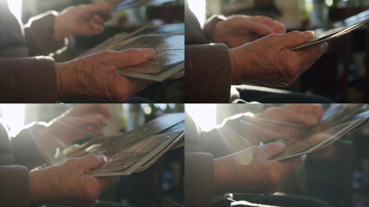 一位老人的手的特写镜头在夕阳的阳光中唱着他一生的黑白照片