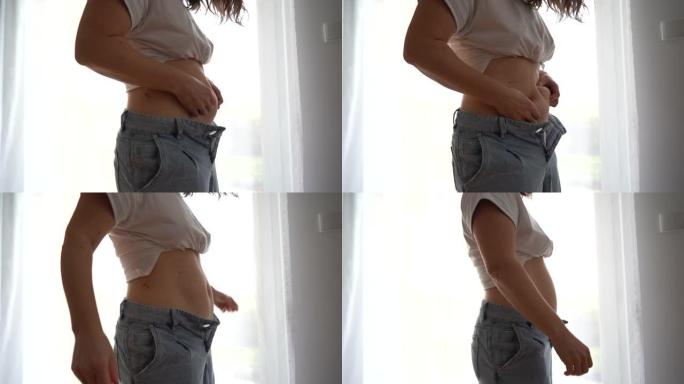 一个超重的女人用手摇动她的腹部脂肪。产后恢复，超重问题，产后抑郁